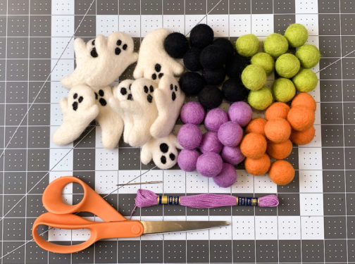 Halloween color felt balls, felt ghost shapes, embroidery floss, needle, scissors