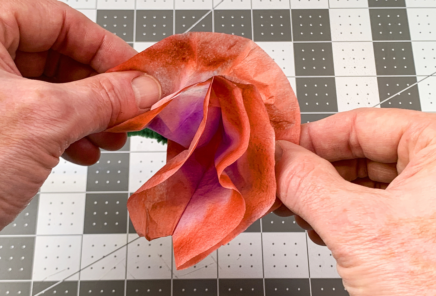 Pulling apart the coffee filter layers to create a flower