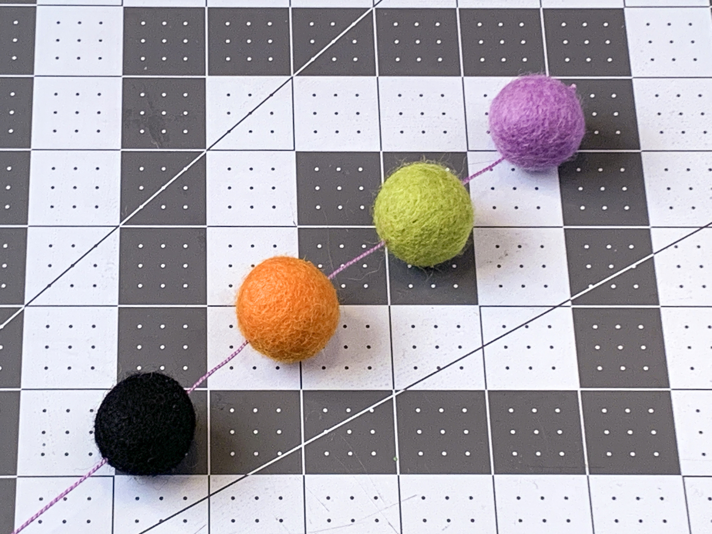 Spacing out the Halloween felt balls on the embroidery floss