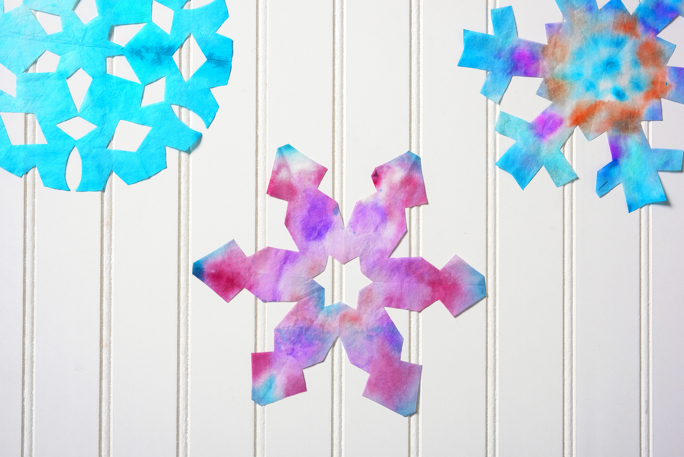 making snowflakes with coffee filters