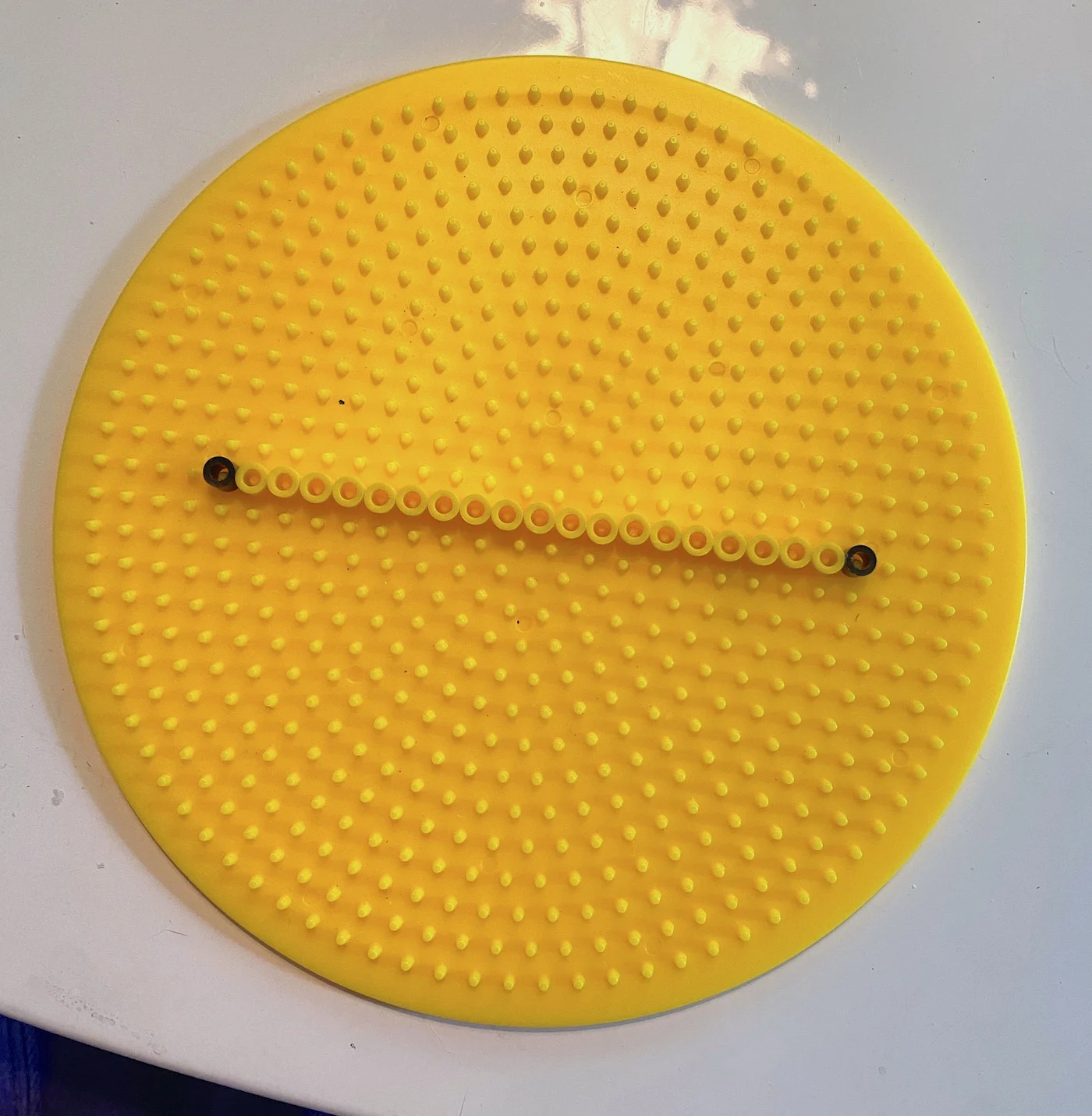 Fuse beads in a straight line on a round pegboard