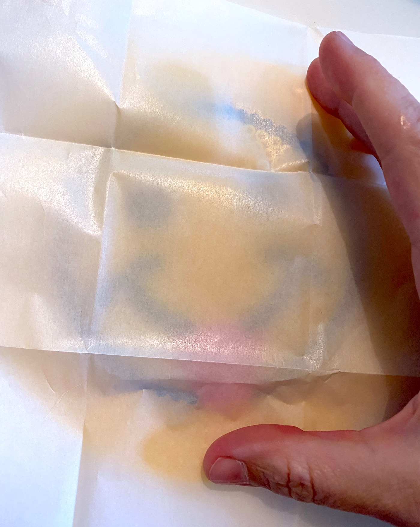 Laying a piece of parchment paper over the beads