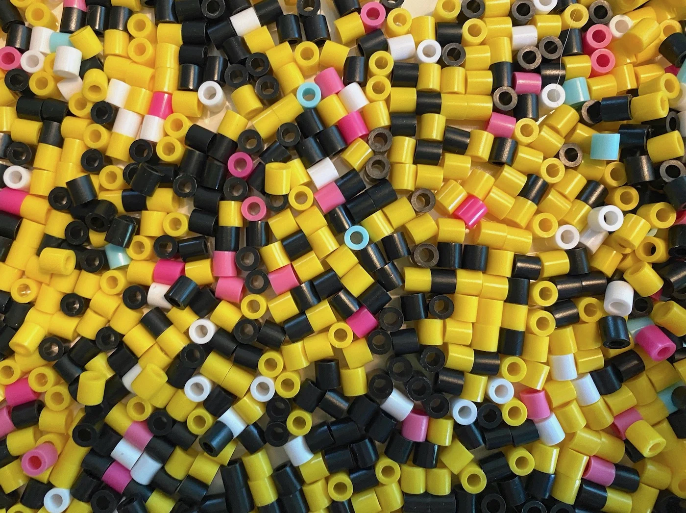 Perler-beads-in-yellow-white-black-and-pink
