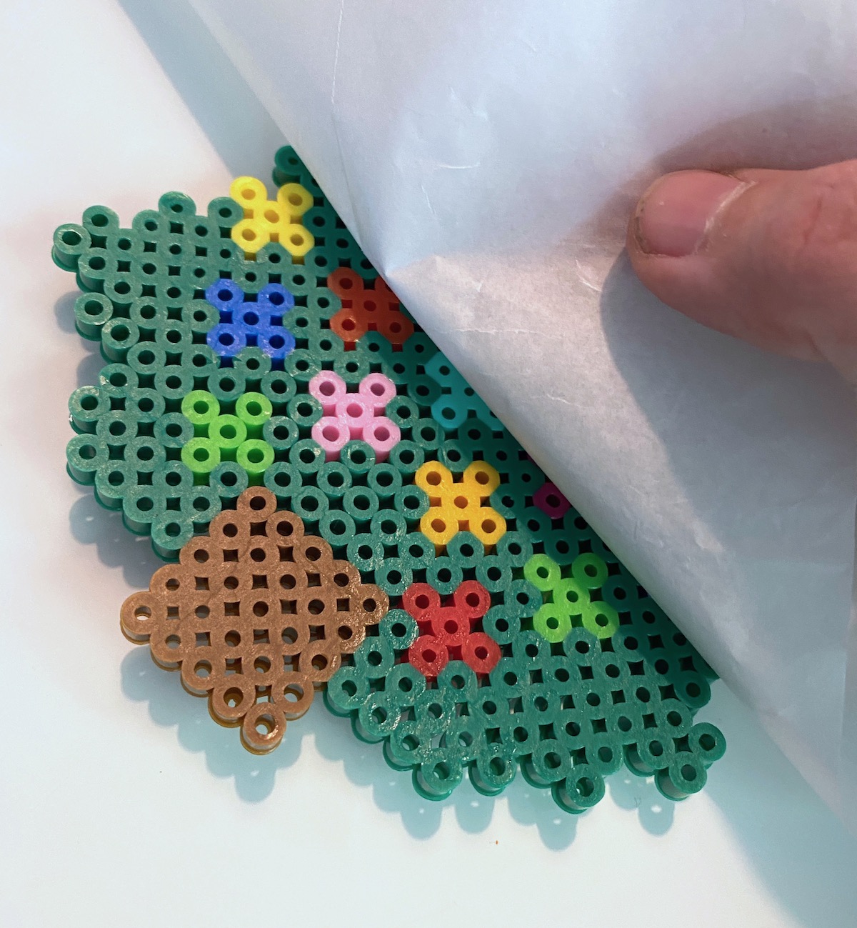 Peeling-back-parchment-paper-from-perler-beads
