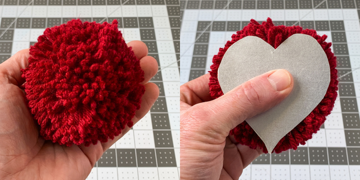Placing a heart template down on a red pom pom