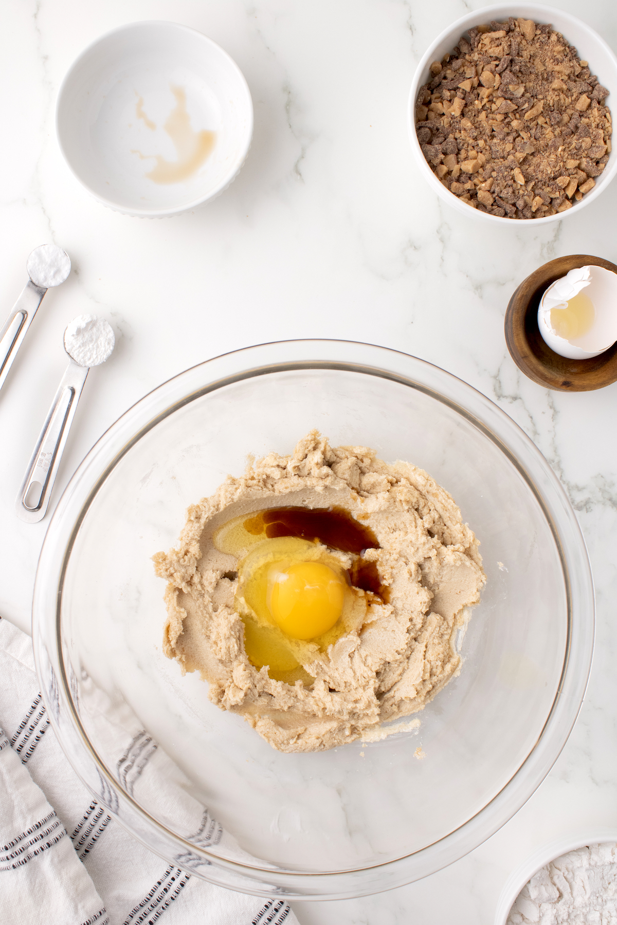 Adding the egg and vanilla to the Heath Bar cookie batter