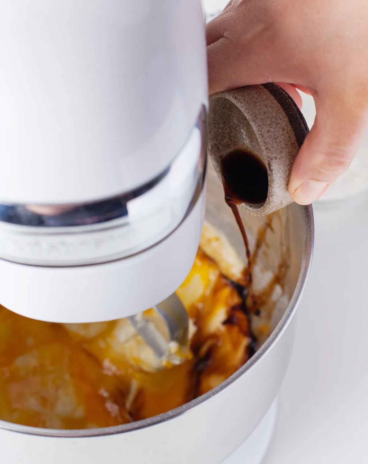 Adding the eggs and vanilla to a mixer