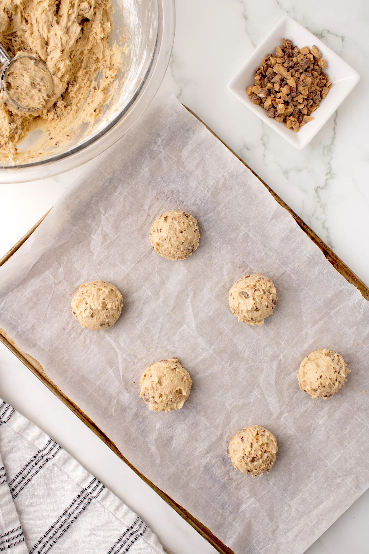 Heath Bar cookie dough scooped onto the cookie sheet