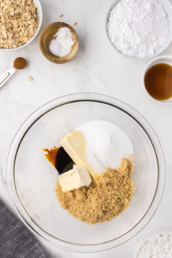 Brown sugar, butter, granulated sugar, and vanilla in a clear glass bowl