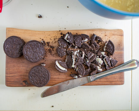 Chopped Oreos on a cutting board with a knife