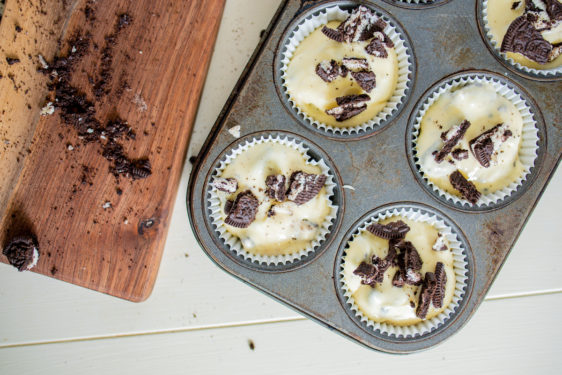 Sprinkling chopped Oreo pieces on top of the batter