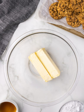 Two sticks of butter in a glass bowl