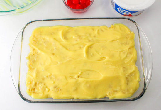 Vanilla pudding poured over the pineapple