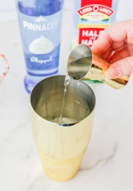 Pouring vodka and half and half into a shaker