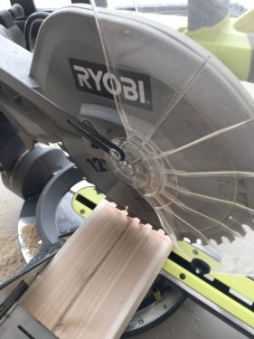 Miter saw cutting cedar decking