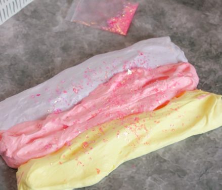 Add glitter to the three colors of slime and twist