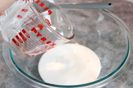 Combine the glue and half cup water in a glass bowl